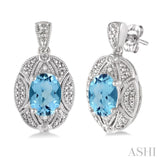 8x6 MM Oval Cut Blue Topaz and 1/50 Ctw Single Cut Diamond Earrings in Sterling Silver